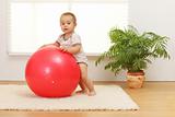 Baby boy with big red ball