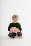 Young Boy Sitting with a Piggy Bank