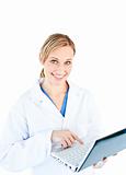 Charming female doctor holding a laptop looking at the camera
