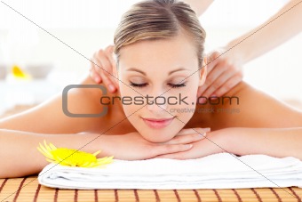 Portrait of a delighted woman lying on a massage table