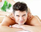 Handsome smiling man enjoying a back massage