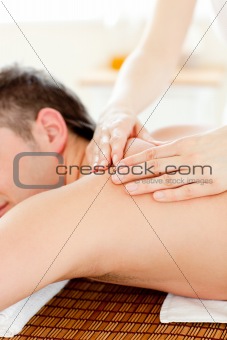Caucasian young man enjoying a back massage 