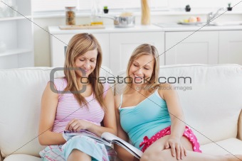 Charming friends reading a book