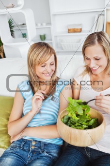 Two friends sharing a salad