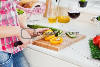 Close-up of a woman cutting paprika at home 