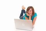 Young woman casually laying on floor with laptop