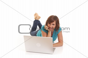 Young woman casually laying on floor with laptop