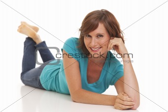 Young woman casually laying on floor with jeans