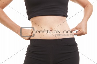 Woman pinching fat on waist while on a diet