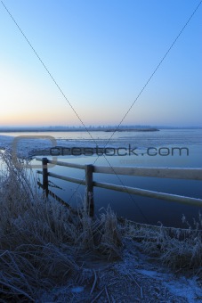 Blue winter landscape in nature with moon and field