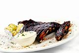 Pork ribs with a baked potato and sour cream