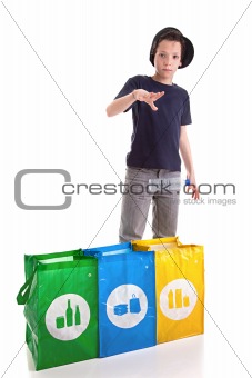 boy putting a plastic bottle to recycle