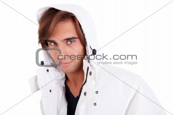 Portrait of a young man with a hood , in autumn/winter clothes