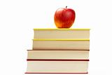 red apple on top of some books