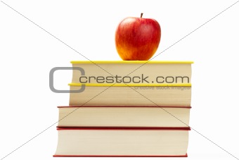 red apple on top of some books