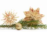 two straw stars and christmas ball with branch