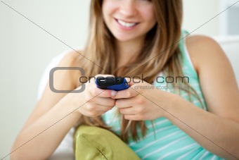Close-up of a beautiful young woman texting with her cellphone o