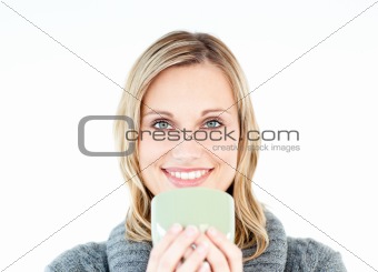 Joyful woman wearing a pullover enjoying a hot coffee