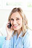 Cheerful businesswoman using her cellphone at home