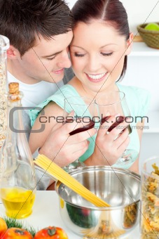 lovely young couple cooking together in the kitchen