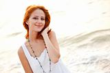 Beautiful young red-haired on the beach