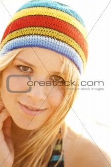 Beautiful young blonde girl in rastafarian hat