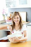 Portrait of a smiling woman cooking a cake in the kitchen