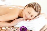 Beautiful relaxed woman lying on a massage table