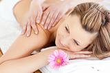 Blissful young woman enjoying a back massage 