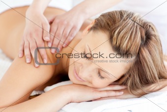 Delighted young woman having a back massage 