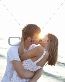 Couple kissing at sunrise