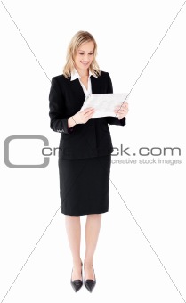 Self-assured businesswoman reading a newspaper 