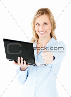 Jolly young businesswoman holding a laptop with thumb up 