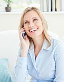 laughing business woman on phone sitting in her living-room