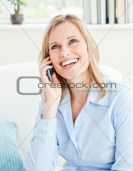 laughing business woman on phone sitting in her living-room