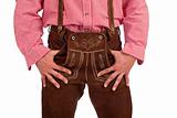 Bavarian man with oktoberfest leather trousers stands casual.