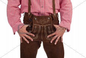 Bavarian man with oktoberfest leather trousers stands casual.