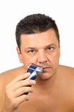 Closeup of a man shaving with electric razor