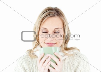 Happy woman enjoying a hot coffee standing 
