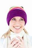 Merry young woman holding a cup wearing a cap in the winter 