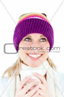 Merry young woman holding a cup wearing a cap in the winter 