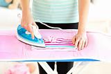 Close-up of a caucasian woman ironing her clothes