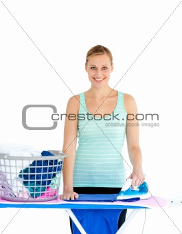 Joyful woman ironing her clothes