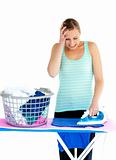 Frustrated woman ironing her clothes