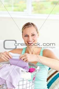 Positive young woman doing the laundry