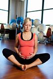 Pregnant woman relaxing and holding belly.
