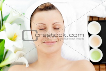 Happy young woman resting on a massage table 
