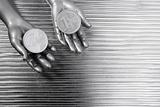 two silver euro coins in futuristic robot hands