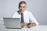 happy senior businessman laptop mobile portrait