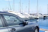 luxury car and yacht sailboats on Spain marina 